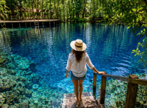Guest swimming in a beautiful east-coast blue hole in Espiritu Santo