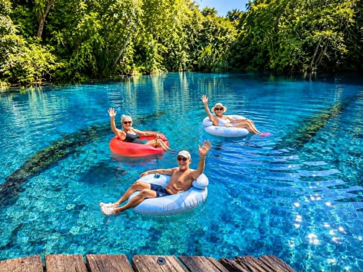 Guests relaxing in floating tubes at the Riri swimming hole